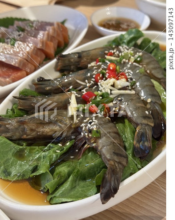 Korean soy sauce marinated raw shrimp with sesame seeds and chili 143097143
