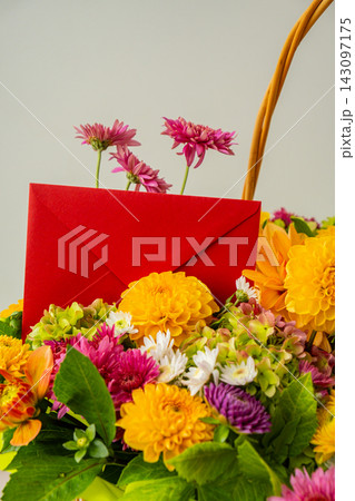 Red envelope gift present idea Flower delivery Autumn Fall Bouquet for Thanksgiving holiday. Seasonal Warm colorful blossom flowers arrangement festive decoration. Selective 143097175