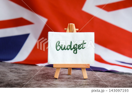 Paper note with words BUDGET on National symbol of Great Britain. British wave the UK silky flag background. Economy federal annual finance planning 143097193