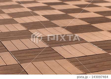 Close-up view of a wooden tile checkerboard pattern on outdoor flooring Close-up view of a wooden tile checkerboard pattern on outdoor flooring 143097464