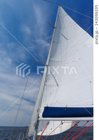 White sail against blue sky on sailing yacht 143099205