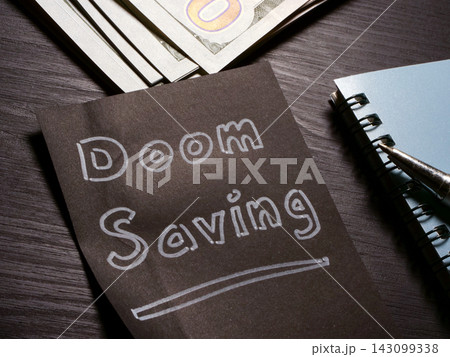 Doom saving message beside cash and note for financial uncertainty. Doom saving message beside cash and note for financial uncertainty. 143099338