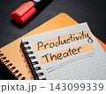 Productivity theater phrase highlighted in notebook for performative workplace culture. 143099339