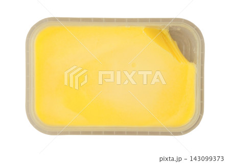 Clarified butter in a plastic container isolated on a white background. Gold ghee. Cooking oil. Lactose free. Top view. 143099373