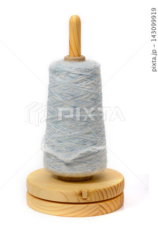 Spinning thread brings joy to crafts in a cozy warm room 143099919
