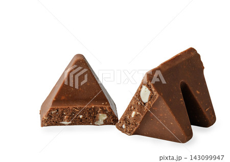 Two separated pieces of triangular milk chocolate with nougat and almonds isolated on a white background Two separated pieces of triangular milk chocolate with nougat and almonds isolated on a white background 143099947