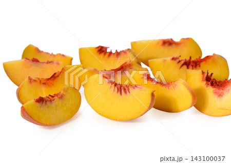 Commercial stock photo of scattered fresh peach wedges with vibrant yellow flesh and red pit details Commercial stock photo of scattered fresh peach wedges with vibrant yellow flesh and red pit details 143100037
