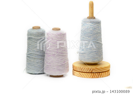 Colors of creativity dance on spools as soft threads twirl in a gentle embrace of artistry and craftsmanship 143100089