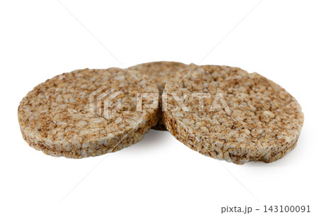 Three round whole grain rice cakes on a white background 143100091