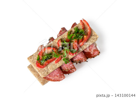 Crispbread sandwich with salami, red bell pepper, and fresh herbs Crispbread sandwich with salami, red bell pepper, and fresh herbs 143100144