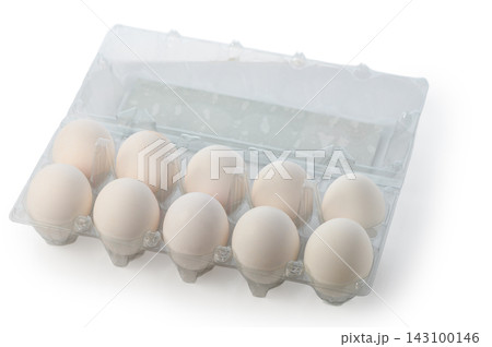 Top-down view of white eggs in a plastic carton 143100146