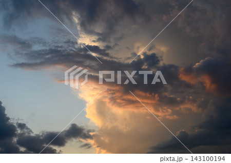Dramatic sunset landscape featuring heavy storm clouds and brilliant golden illumination Dramatic sunset landscape featuring heavy storm clouds and brilliant golden illumination 143100194