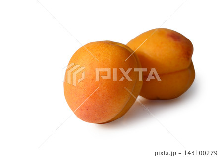 Vibrant and juicy apricots resting on a clean white surface, ready to delight taste buds with their sweetness 143100279