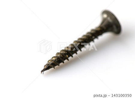 Commercial product photography of a metal drywall screw against a white background 143100350