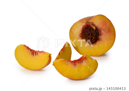 Commercial stock photo of fresh sliced ripe peaches with a peach half and pit on a white background Commercial stock photo of fresh sliced ripe peaches with a peach half and pit on a white background 143100413