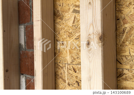 Construction of wood frame walls of a new country house site. Unfinished construction work inside. Construction of wood frame walls of a new country house site. Unfinished construction work inside. 143100689