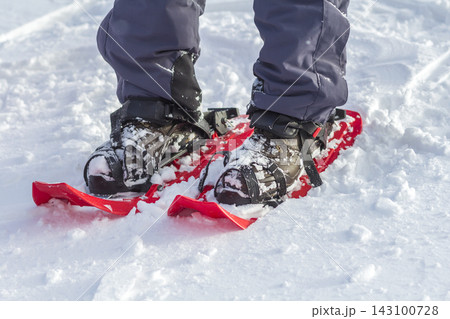 Close-up of man skier feet and legs in short plastic bright professional wide skis on white snow sunny copy space background. Active lifestyle, winter extreme sports and recreation concept. Close-up of man skier feet and legs in short plastic bright professional wide skis on white snow sunny copy space background. Active lifestyle, winter extreme sports and recreation concept. 143100728