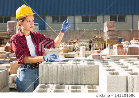 Female worker beckoning come here at construction store 143101690