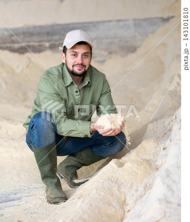 Man farmer checking quality of maize flour Man farmer checking quality of maize flour 143101810