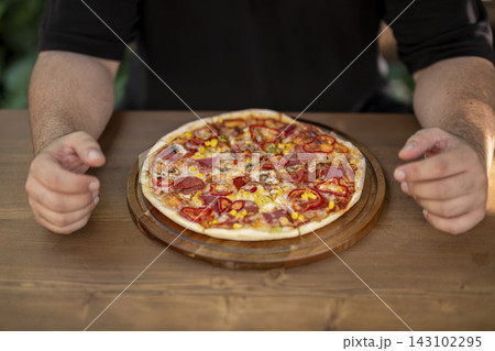 Man Picking Up a Slice of Delicious Pizza. Man Picking Up a Slice of Delicious Pizza. 143102295