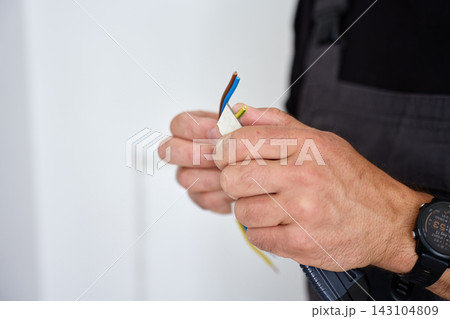 Man preparing electrical wires for installation 143104809