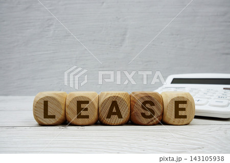 LEASE alphabet letters with calculator on wooden background LEASE alphabet letters with calculator on wooden background 143105938