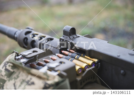 Close Up of Ammunition Belt Loaded Into Heavy Machine Gun Close Up of Ammunition Belt Loaded Into Heavy Machine Gun 143106111