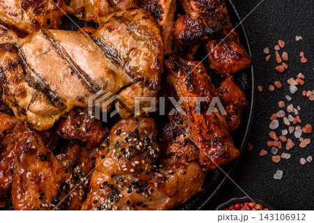 Grilled meat set featuring chicken breast, wings, and ribs seasoned with spices. Grilled meat set 143106912