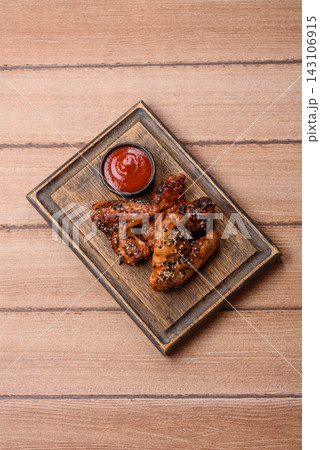 Grilled chicken wings with teriyaki sauce, seasoned with salt and spices. Chicken wings 143106915