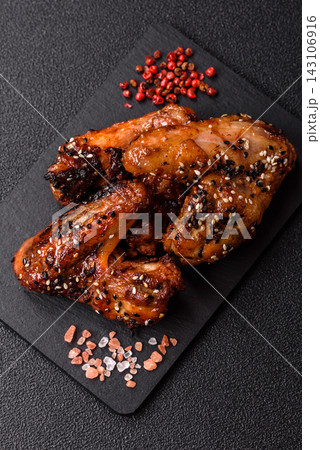 Grilled chicken wings with teriyaki sauce, seasoned with salt and spices. Chicken wings 143106916
