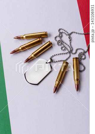 A dog tag on the Italian flag, serving as a conceptual backdrop representing Europe's defense A dog tag on the Italian flag, serving as a conceptual backdrop representing Europe's defense 143106931