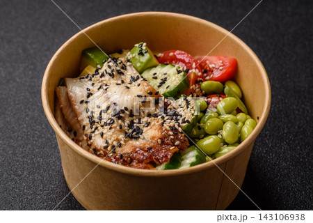 An Asian style bowl with eel, edamame, avocado, tomatoes, and lettuce. A eel and vegetable bowl An Asian style bowl with eel, edamame, avocado, tomatoes, and lettuce. A eel and vegetable bowl 143106938
