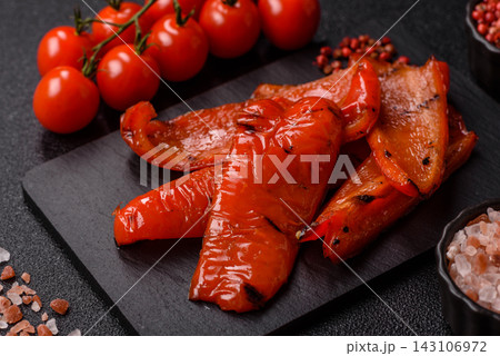 Grilled red bell pepper slices seasoned with salt and spices. Grilled sweet pepper Grilled red bell pepper slices seasoned with salt and spices. Grilled sweet pepper 143106972