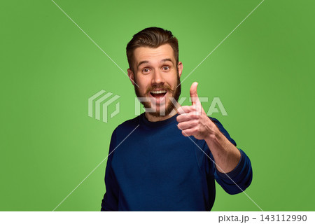Excited bearded man showing thumbs up on green studio background. Excited bearded man showing thumbs up on green studio background. 143112990