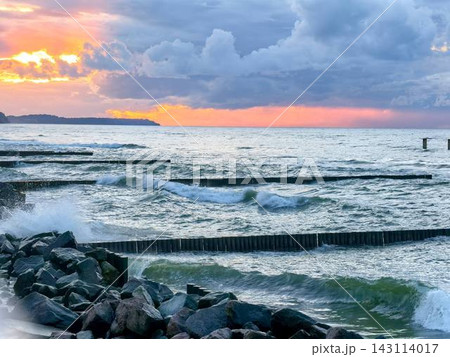 Sunset over the rough Baltic Sea and breakwater Sunset over the rough Baltic Sea and breakwater 143114017
