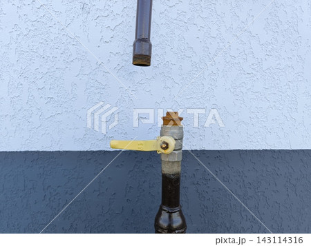 Gas pipe with a shut-off valve on a textured wall Gas pipe with a shut-off valve on a textured wall 143114316