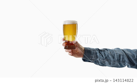 Tall glass of beer held by hand with clean copy space. 143114822