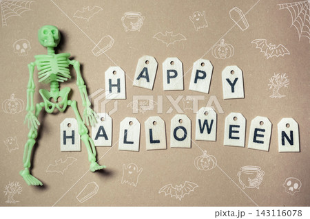 Halloween Skeleton and Letter Tags on Brown Background 143116078