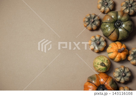 Assorted Decorative Gourds on Brown Background Assorted Decorative Gourds on Brown Background 143116108