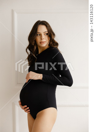 Expectant Mother Embracing Pregnancy Journey 143116120