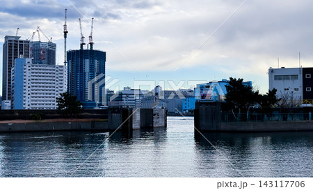 Tokyo Waterfront Gate and High Rise Construction across Calm Water 143117706