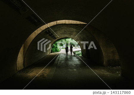Pedestrians Walking through a Large Curved Pedestrian Tunnel 143117860