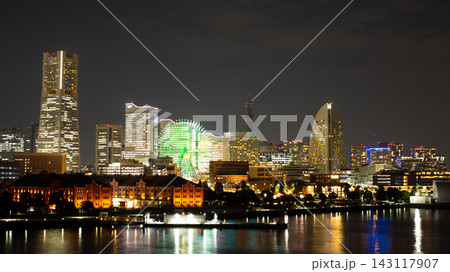 Historic Red Brick Warehouse and Modern Towers Reflected in Calm Water at Night 143117907