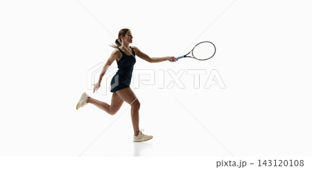 Female tennis player running forward for extended forehand shot on white studio background 143120108