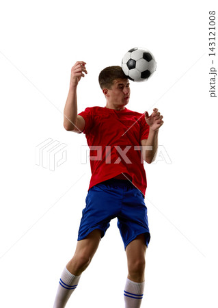 Player preparing controlled header beneath descending football Player preparing controlled header beneath descending football 143121008