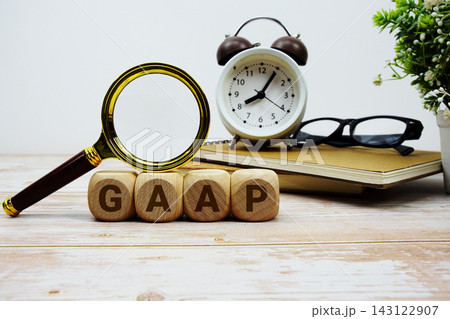GAAP Generally Accepted Accounting Principles alphabet letters with magnifying glass, calculator and alarm clock GAAP Generally Accepted Accounting Principles alphabet letters with magnifying glass, calculator and alarm clock 143122907