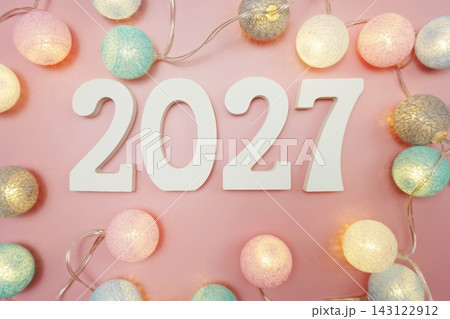 Happy New Year 2027 festive background with space on pink background Happy New Year 2027 festive background with space on pink background 143122912