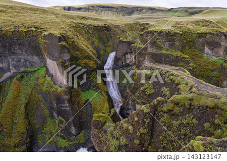 Mogafoss waterfall framed by mossy cliffs in Fjadrargljufur canyon, Iceland 143123147