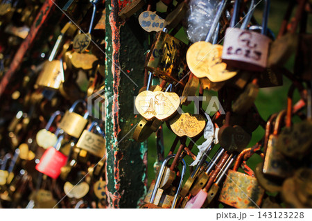 Souvenir padlocks hung by tourists on a fence in Montmartre, Paris, France Souvenir padlocks hung by tourists on a fence in Montmartre, Paris, France 143123228