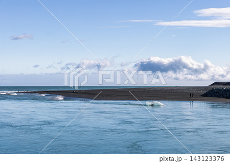Floating ice beside black sand river mouth at Diamond Beach in southeast Iceland Floating ice beside black sand river mouth at Diamond Beach in southeast Iceland 143123376